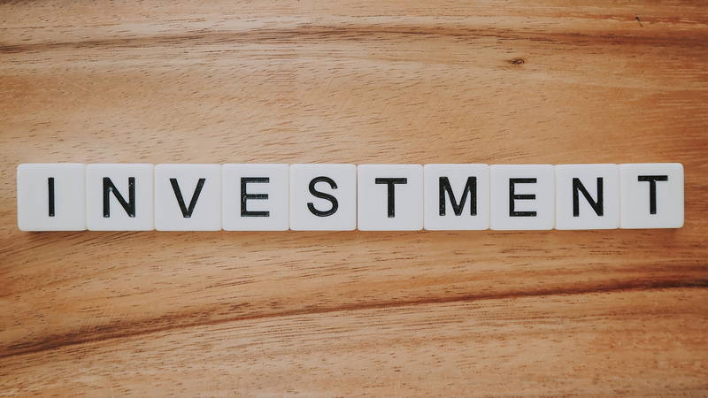 Investment as scrabble word. Invest in your business with a business website.